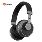 Tazata wireless over-ear headphones in black and gray, shown from a three-quarters angle on a white background with the Tazata logo in the top-left corner.