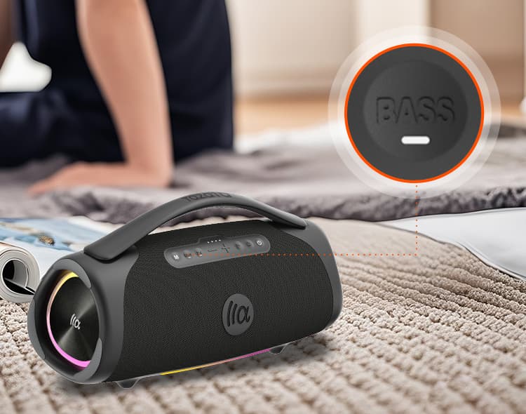 Portable speaker with bass indicator on a carpeted floor