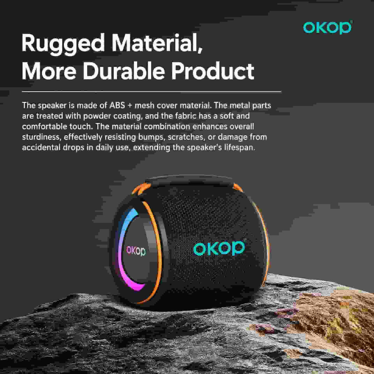 A black OKOP portable speaker with orange trim and a colorful LED ring, resting on a rock against a dark gray background with promotional text about rugged material and durability.