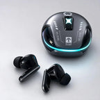 A pair of black true wireless earbuds and their matching charging case on a light gray studio background. The case is dark gray with a glowing cyan LED ring and white printed markings including 'ZCAT'.